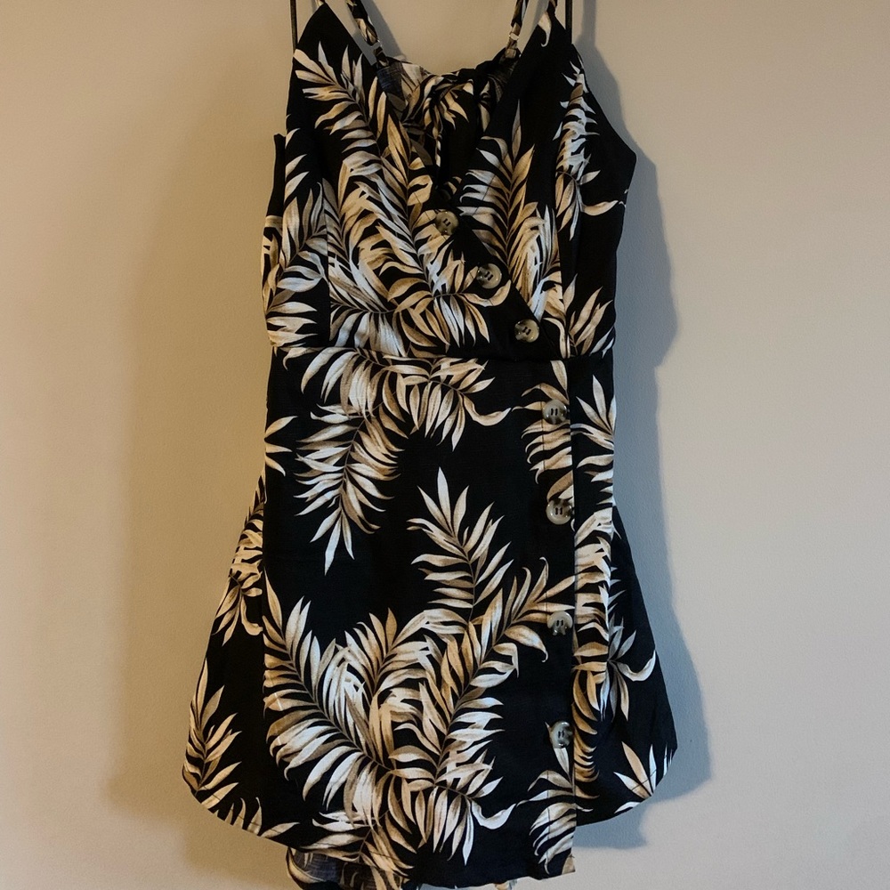 Revamped medium romper/dress with black, white, tan leaf design. Cutout back